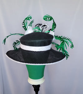 Black Wide Brim Sinamay Hat adorned in green and white embellishments